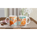 Deux mugs en céramique blancs, motif mandarines et texte « Café frappé ! »
